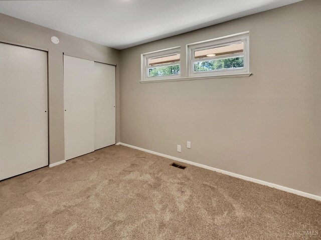 824 Cascade Rd, Forest Park, OH 45240 - unfurnished bedroom featuring carpet, multiple closets, and baseboards