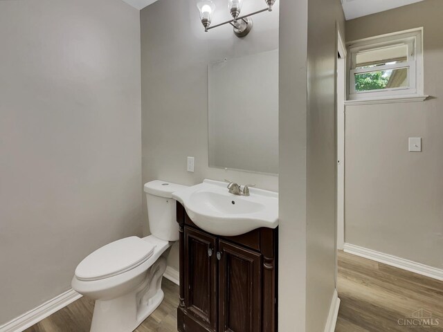 824 Cascade Rd, Forest Park, OH 45240 - half bath with wood finished floors, toilet, baseboards, and vanity