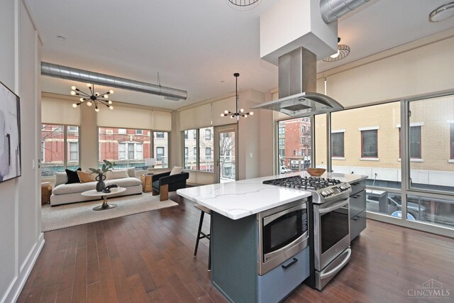 1 Mercer St Unit 204, Cincinnati, OH 45202 - kitchen featuring an inviting chandelier, open floor plan, dark wood-style floors, island exhaust hood, and appliances with stainless steel finishes