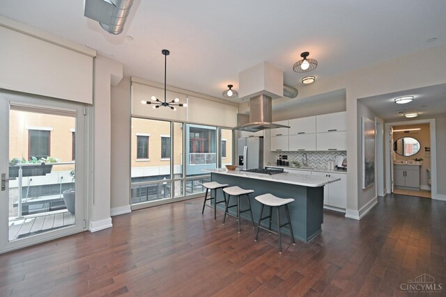 1 Mercer St Unit 204, Cincinnati, OH 45202 - kitchen featuring dark wood finished floors, gas stovetop, white cabinets, and stainless steel fridge with ice dispenser