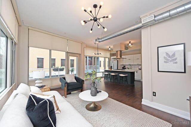 1 Mercer St Unit 204, Cincinnati, OH 45202 - living area with baseboards, plenty of natural light, dark wood-style flooring, and a notable chandelier