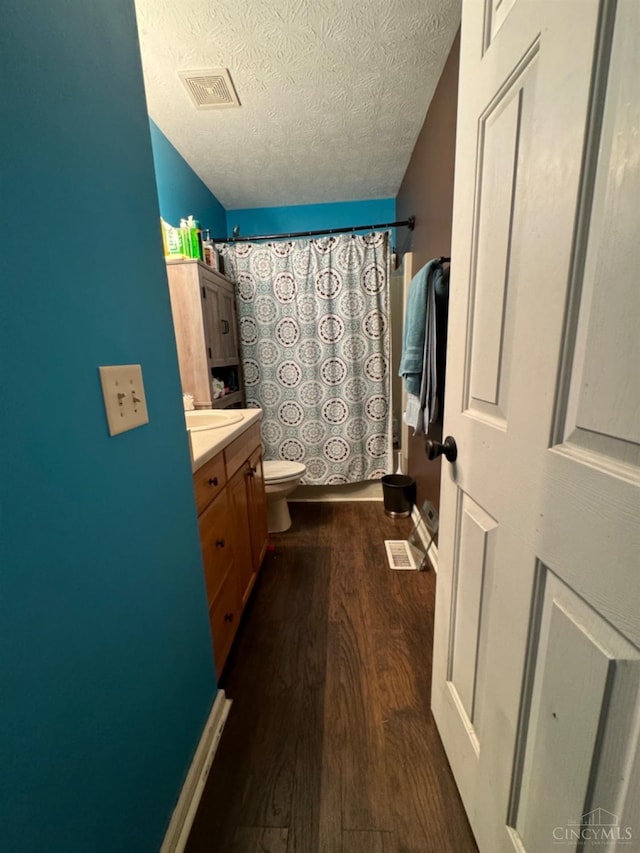 5506 Glen Ct, Carlisle, OH 45005 - bathroom with curtained shower, vanity, a textured ceiling, hardwood / wood-style flooring, and toilet