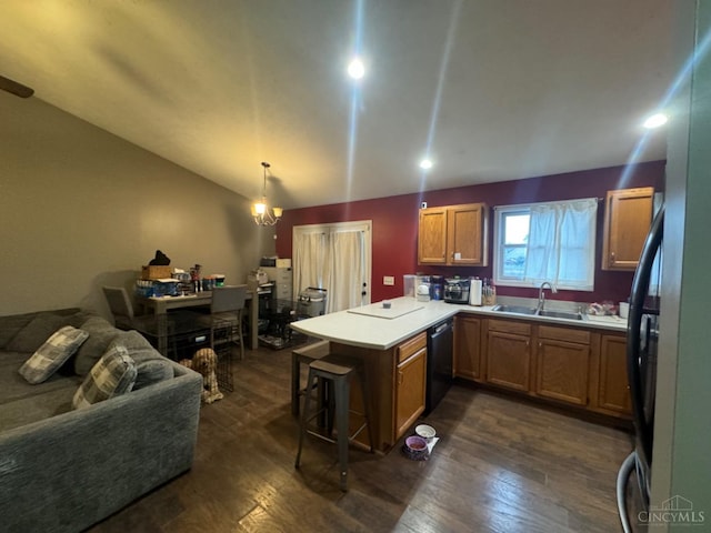 5506 Glen Ct, Carlisle, OH 45005 - kitchen featuring kitchen peninsula, black dishwasher, pendant lighting, sink, and a notable chandelier