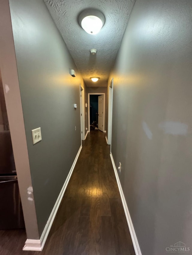 5506 Glen Ct, Carlisle, OH 45005 - hallway featuring a textured ceiling and dark hardwood / wood-style floors