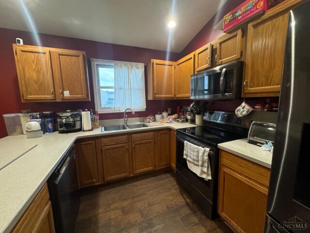 5506 Glen Ct, Carlisle, OH 45005 - kitchen with black appliances, lofted ceiling, sink, and dark hardwood / wood-style flooring