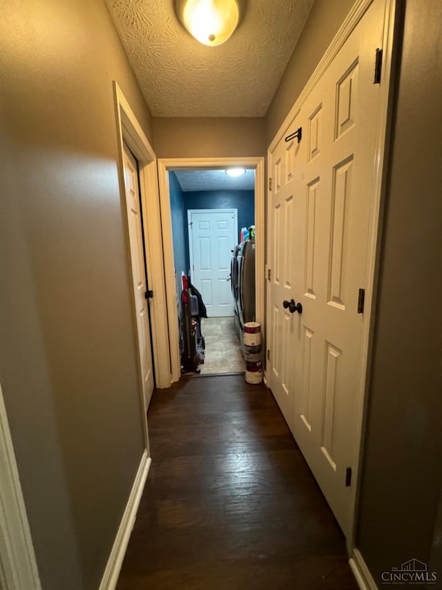 5506 Glen Ct, Carlisle, OH 45005 - corridor with a textured ceiling, separate washer and dryer, and dark wood-type flooring