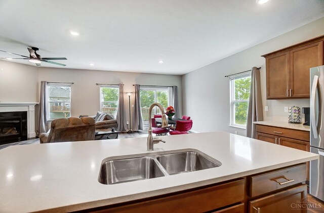 61 Goldfish Ln, Pierce Twp, OH 45102 - kitchen featuring a sink, open floor plan, light countertops, brown cabinets, and healthy amount of natural light