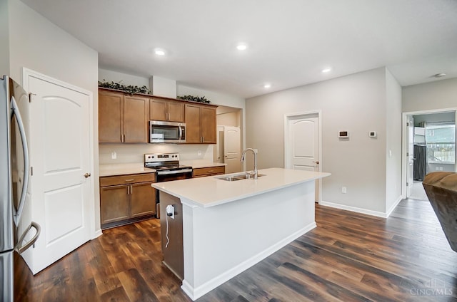 61 Goldfish Ln, Pierce Twp, OH 45102 - kitchen with appliances with stainless steel finishes, a sink, dark wood-type flooring, a kitchen island with sink, and light countertops