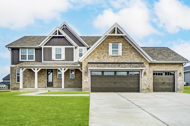 craftsman-style home with a shingled roof, a porch, board and batten siding, driveway, and a front lawn