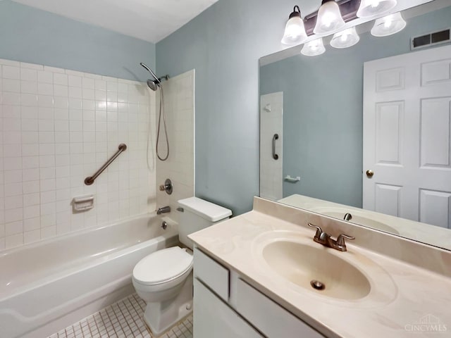 full bathroom featuring tile patterned floors, toilet, tiled shower / bath combo, and vanity