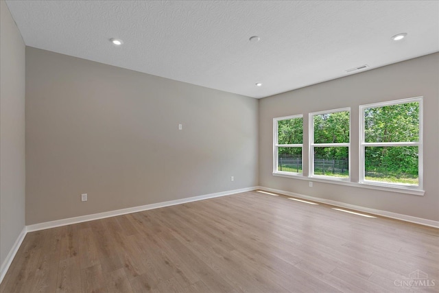 1658 Whitewater Trails Blvd, Harrison, OH 45030 - spare room featuring light wood-style flooring, baseboards, a textured ceiling, and recessed lighting
