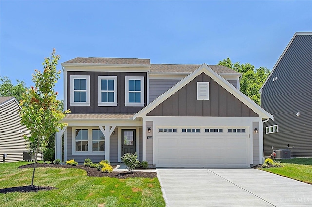 1658 Whitewater Trails Blvd, Harrison, OH 45030 - view of front of property featuring board and batten siding, concrete driveway, central AC, a garage, and a front lawn