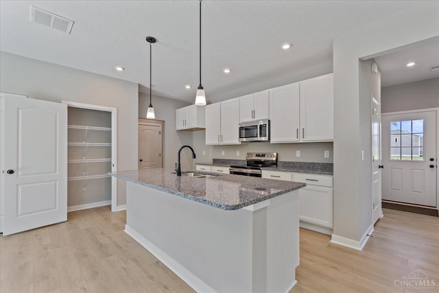 1658 Whitewater Trails Blvd, Harrison, OH 45030 - kitchen featuring a sink, stainless steel appliances, light wood-style floors, white cabinets, and recessed lighting