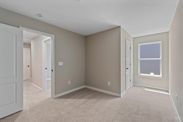 1658 Whitewater Trails Blvd, Harrison, OH 45030 - empty room with light carpet, baseboards, a smoke detector, and attic access