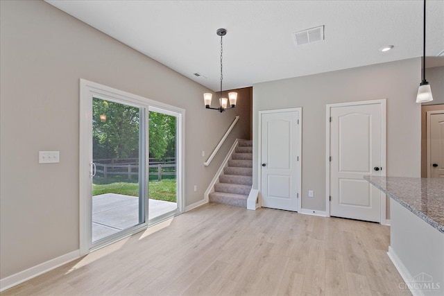 1658 Whitewater Trails Blvd, Harrison, OH 45030 - unfurnished dining area with light wood finished floors, stairway, a chandelier, and baseboards