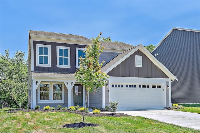 1658 Whitewater Trails Blvd, Harrison, OH 45030 - view of front of property with board and batten siding, an attached garage, concrete driveway, and a front yard