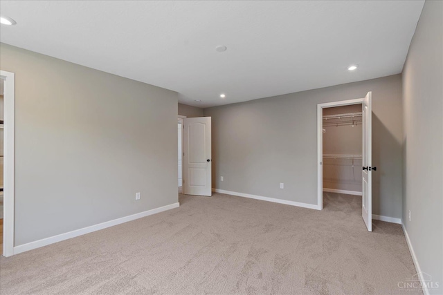 1658 Whitewater Trails Blvd, Harrison, OH 45030 - unfurnished bedroom with carpet, a walk in closet, baseboards, recessed lighting, and a closet