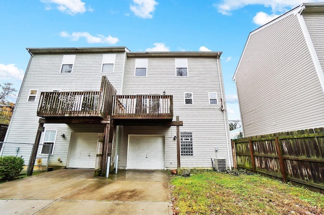 818 William Howard Taft Rd, Cincinnati, OH 45206 - rear view of house with an attached garage, concrete driveway, and a balcony