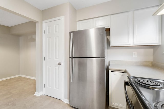 818 William Howard Taft Rd, Cincinnati, OH 45206 - kitchen with freestanding refrigerator, white cabinetry, light countertops, and electric range