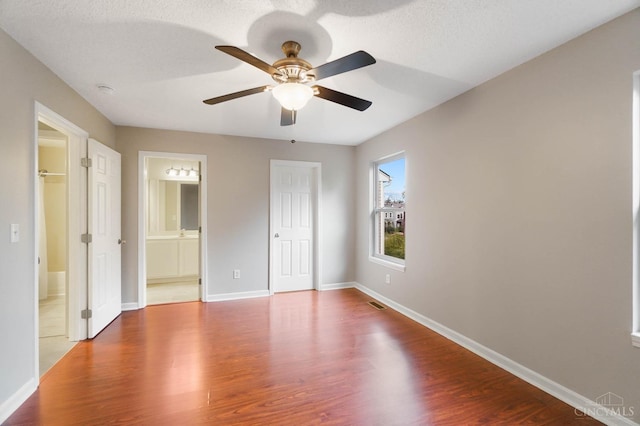 818 William Howard Taft Rd, Cincinnati, OH 45206 - unfurnished bedroom featuring dark wood-style floors, ensuite bath, a closet, and ceiling fan