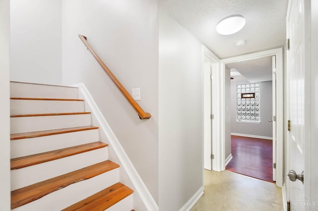 818 William Howard Taft Rd, Cincinnati, OH 45206 - staircase with a textured ceiling and baseboards