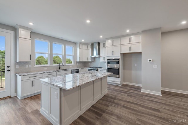 7230 Abington Way Unit 21805, West Chester, OH 45069 - kitchen with wall chimney range hood, stainless steel appliances, dark wood-style flooring, a center island, and recessed lighting