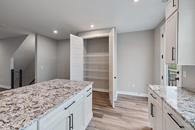 7230 Abington Way Unit 21805, West Chester, OH 45069 - kitchen featuring light wood-style floors, light stone countertops, recessed lighting, and white cabinets