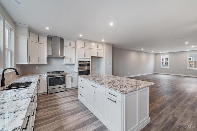 7230 Abington Way Unit 21805, West Chester, OH 45069 - kitchen with wall chimney range hood, stainless steel appliances, recessed lighting, wood finished floors, and white cabinets
