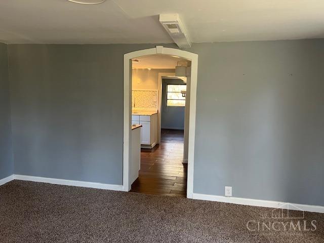 338 Wiltsee Ave, Miami Twp, OH 45140 - unfurnished room with arched walkways and dark carpet