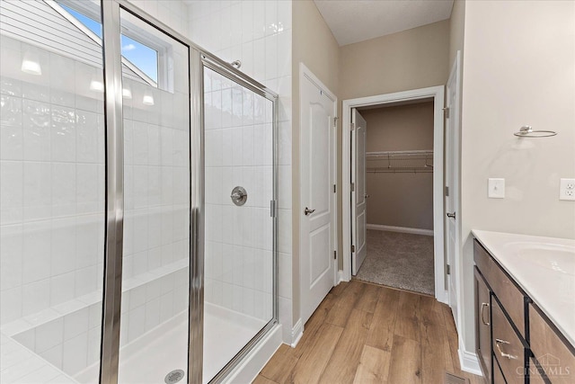 4517 Renaissance Park Dr, Middletown, OH 45005 - bathroom with wood finished floors, a stall shower, vanity, and a spacious closet
