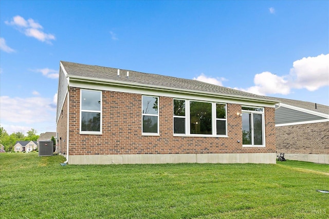 4517 Renaissance Park Dr, Middletown, OH 45005 - view of home's exterior with central AC, a lawn, brick siding, and a shingled roof
