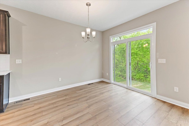 4517 Renaissance Park Dr, Middletown, OH 45005 - unfurnished dining area with baseboards, light wood-type flooring, and a chandelier