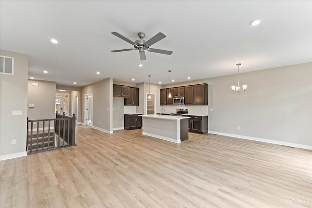4517 Renaissance Park Dr, Middletown, OH 45005 - kitchen featuring stainless steel appliances, open floor plan, dark brown cabinets, baseboards, and recessed lighting