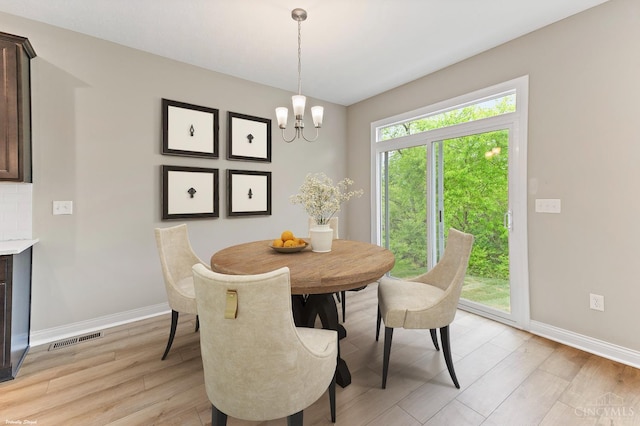 4517 Renaissance Park Dr, Middletown, OH 45005 - dining space with baseboards, light wood-style floors, and a chandelier