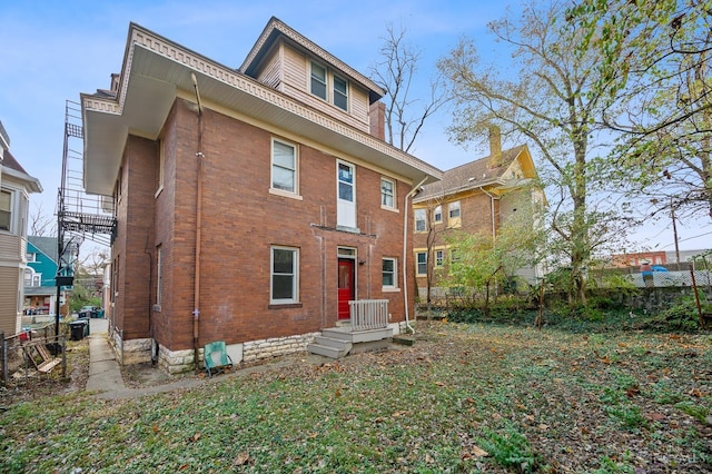 back of property with brick siding and fence