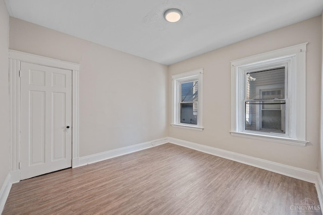 unfurnished room featuring wood finished floors and baseboards