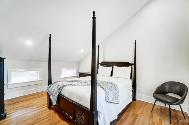 bedroom featuring vaulted ceiling and hardwood / wood-style flooring