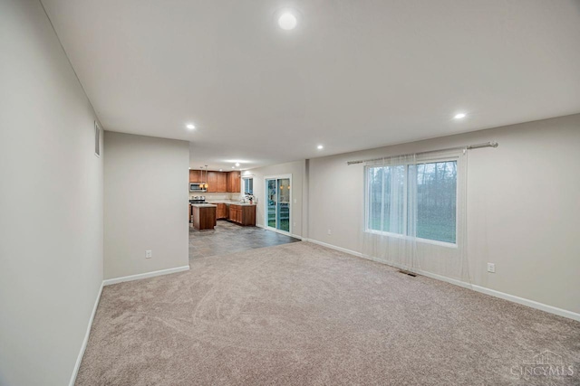 1295 Eagle Blvd, Hamilton Twp, OH 45039 - unfurnished living room featuring light colored carpet, recessed lighting, and baseboards