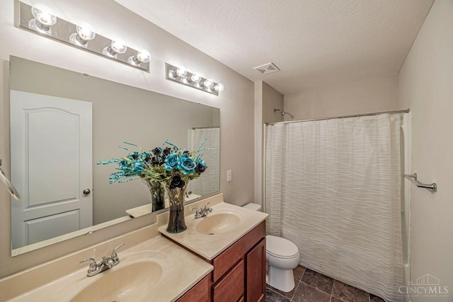 1295 Eagle Blvd, Hamilton Twp, OH 45039 - bathroom with toilet, double vanity, a textured ceiling, and tile patterned floors