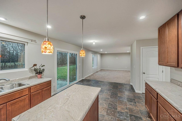 1295 Eagle Blvd, Hamilton Twp, OH 45039 - kitchen with a sink, brown cabinets, light countertops, stone finish flooring, and recessed lighting