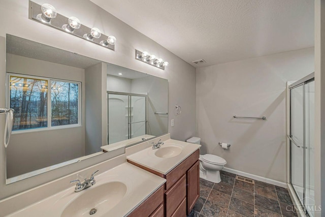 1295 Eagle Blvd, Hamilton Twp, OH 45039 - bathroom with a stall shower, baseboards, a textured ceiling, stone finish floors, and double vanity