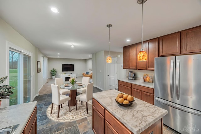 1295 Eagle Blvd, Hamilton Twp, OH 45039 - kitchen with freestanding refrigerator, brown cabinets, open floor plan, decorative light fixtures, and recessed lighting