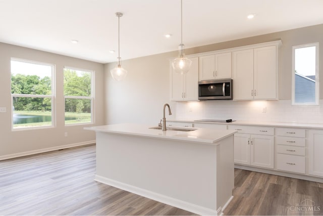 4147 Amelia Olive Branch Rd, Batavia Twp, OH 45103 - kitchen with stainless steel microwave, a sink, light wood-type flooring, backsplash, and recessed lighting