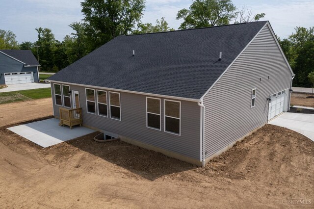 4147 Amelia Olive Branch Rd, Batavia Twp, OH 45103 - rear view of house with a shingled roof, a garage, and concrete driveway