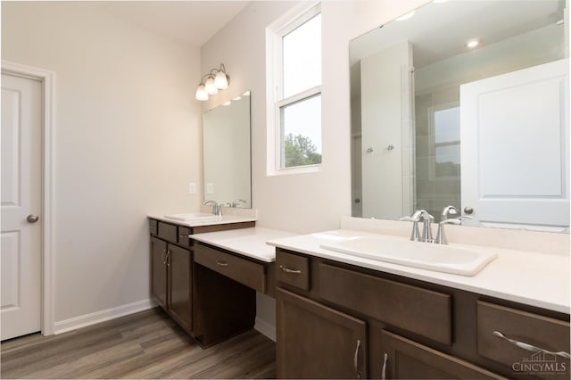 4147 Amelia Olive Branch Rd, Batavia Twp, OH 45103 - bathroom with two vanities, wood finished floors, tiled shower, and baseboards
