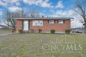 view of front of home with a front yard and brick siding