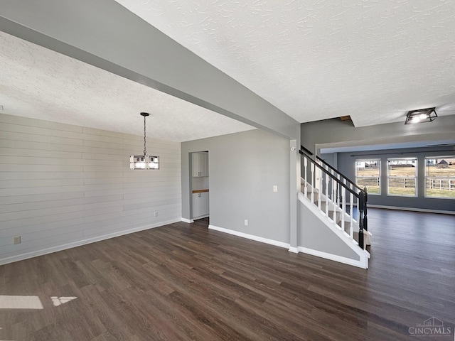 1789 Greentree Meadows Dr, Turtle Creek Twp, OH 45036 - unfurnished living room featuring a textured ceiling, a chandelier, baseboards, stairs, and dark wood finished floors