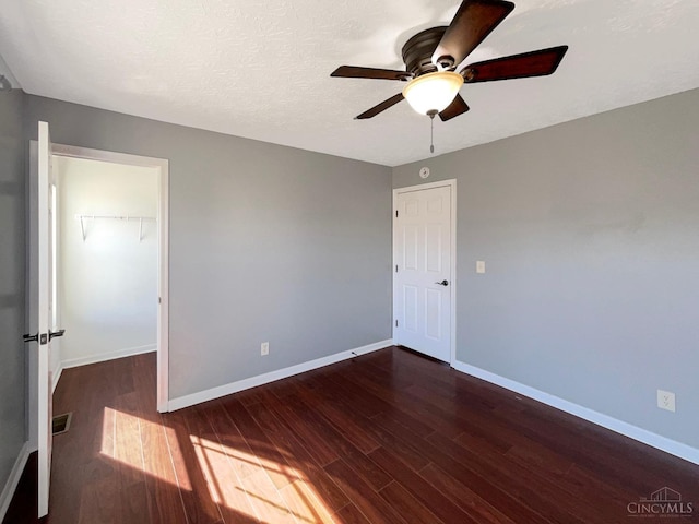 1789 Greentree Meadows Dr, Turtle Creek Twp, OH 45036 - unfurnished bedroom with a walk in closet, dark wood-style flooring, a closet, visible vents, and baseboards