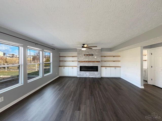 1789 Greentree Meadows Dr, Turtle Creek Twp, OH 45036 - unfurnished living room featuring dark wood-style floors, a large fireplace, ceiling fan, and baseboards
