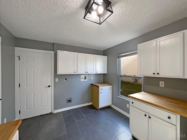 1789 Greentree Meadows Dr, Turtle Creek Twp, OH 45036 - laundry room with a textured ceiling, hookup for a washing machine, baseboards, cabinet space, and electric dryer hookup